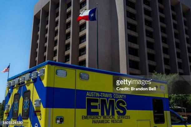 The Texas State flag is seen blowing near an EMS ambulance on August 08, 2023 in Austin, Texas. EMT were called after the patient was found passed...