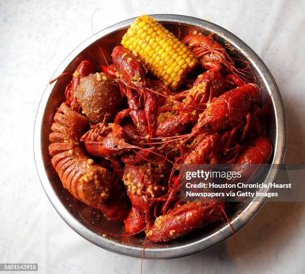 Three-pound order of spicy Vietnamese-Cajun crawfish at Crawfish & Noodles made by tossing boiled crawfish in garlic butter, spices and ground chile...
