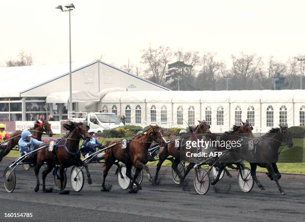 French Franck Nivard , riding his horse "Ready Cash", celebrates before winning the 91st Prix d'Amerique, the most prestigious trotting race in...