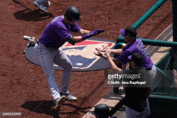 Michael Toglia of the Colorado Rockies celebrates with Bud Black after hitting a home run against the Washington Nationals during the sixth inning at...