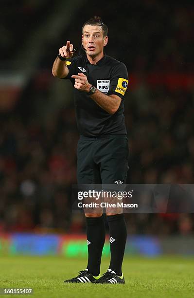 Referee Mark Clattenburg gestures during the FA Cup with Budweiser Fourth Round match between Manchester United and Fulham at Old Trafford on January...