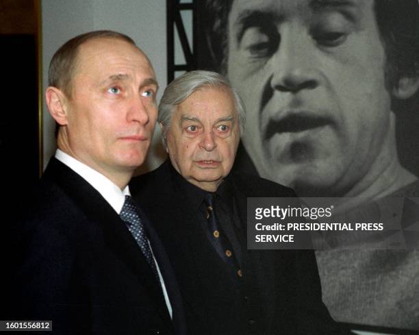 Russian President Vladimir Putin and the chief director of Moscow's Taganka Theatre Yuri Lyubimov stand 25 January 2003 in front of the portrait of...