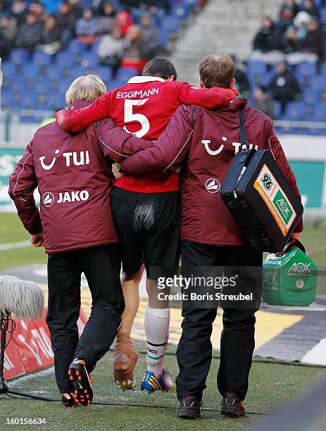 Mario Eggimann of Hannover leaves the pitch with team doctors after getting injured during the Bundesliga match between Hannover 96 and VfL Wolfsburg...