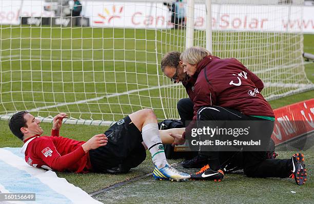 Mario Eggimann of Hannover lies injured on the ground during the Bundesliga match between Hannover 96 and VfL Wolfsburg at AWD Arena on January 26,...