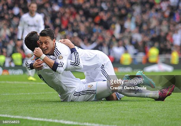 Mesut Ozil of Real Madrid CF celbrates with Cristiano Ronaldo after Ronaldo scored Real's 2nd goal during the La Liga match between Real Madrid CF...
