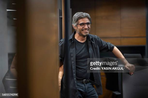 Turkish investigative journalist Baris Pehlivan reacts at his lawyer's office before surrendering himself to the Silivri prison in Istanbul, on...