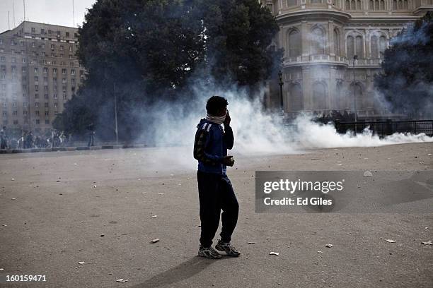 An Egyptian protester stands with a rock in his hand during a demonstration in Tahrir Square on January 27, 2013 in Cairo, Egypt. Violent protests...