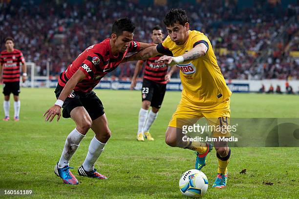Guillermo Martin of Atlas struggles for the ball with Rubens Sambueza of America during a match between Atlas v America as part of the Clausura 2013...