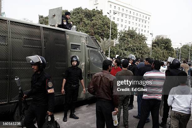 Egyptian riot policemen stand by an armoured vehicle parked amonst Egyptian civilians during a demonstration in Tahrir Square on January 27, 2013 in...