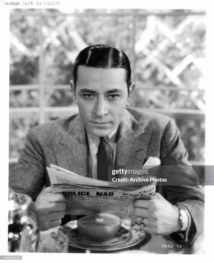 George Raft Package George Raft holding newspaper in a scene from the film 'Pick-Up ...