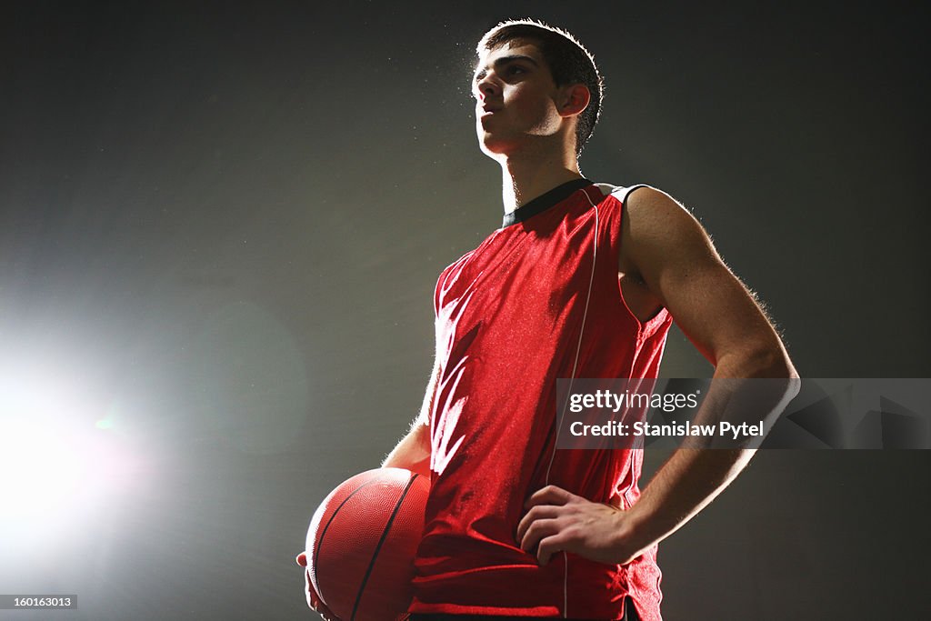 Basketball player standing with ball