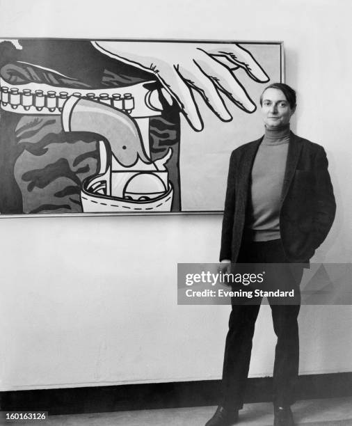 American pop artist Roy Lichtenstein standing in front of his 1963 work 'Fastest Gun' at the Tate Gallery, London, 4th January 1968.