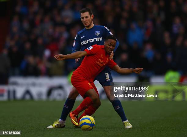 Raheem Sterling of Liverpool competes with Jonathan Grounds of Oldham Athletic during the FA Cup with Budweiser Fourth Round match between Oldham...