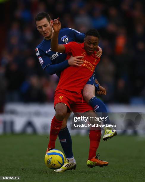 Raheem Sterling of Liverpool competes with Jonathan Grounds of Oldham Athletic during the FA Cup with Budweiser Fourth Round match between Oldham...