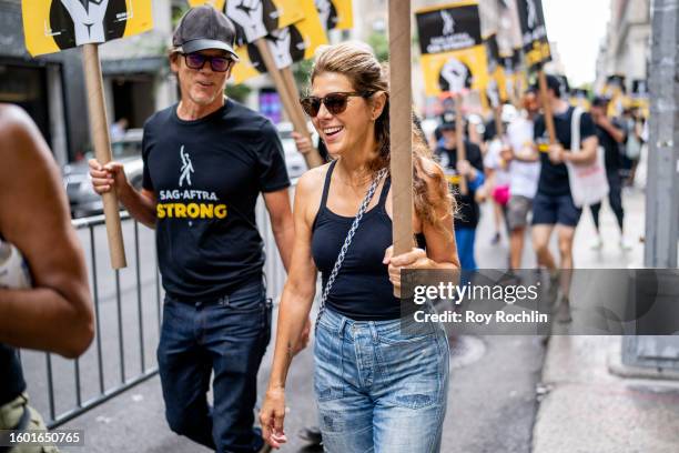 Kevin Bacon and Marisa Tomei join the SAG- AFTRA picket line outside the Warner Bros./ Discovery office on August 08, 2023 in New York City. Members...