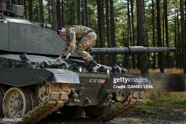 Member of the Royal Tank Regiment gets down from a tank as he takes part in a training session of British forces and Challengers tanks at the...