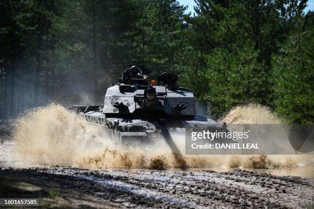 Member of the British army drives a tank as he takes part in a training session of British forces and Challengers tanks at the Ministry of Defence...