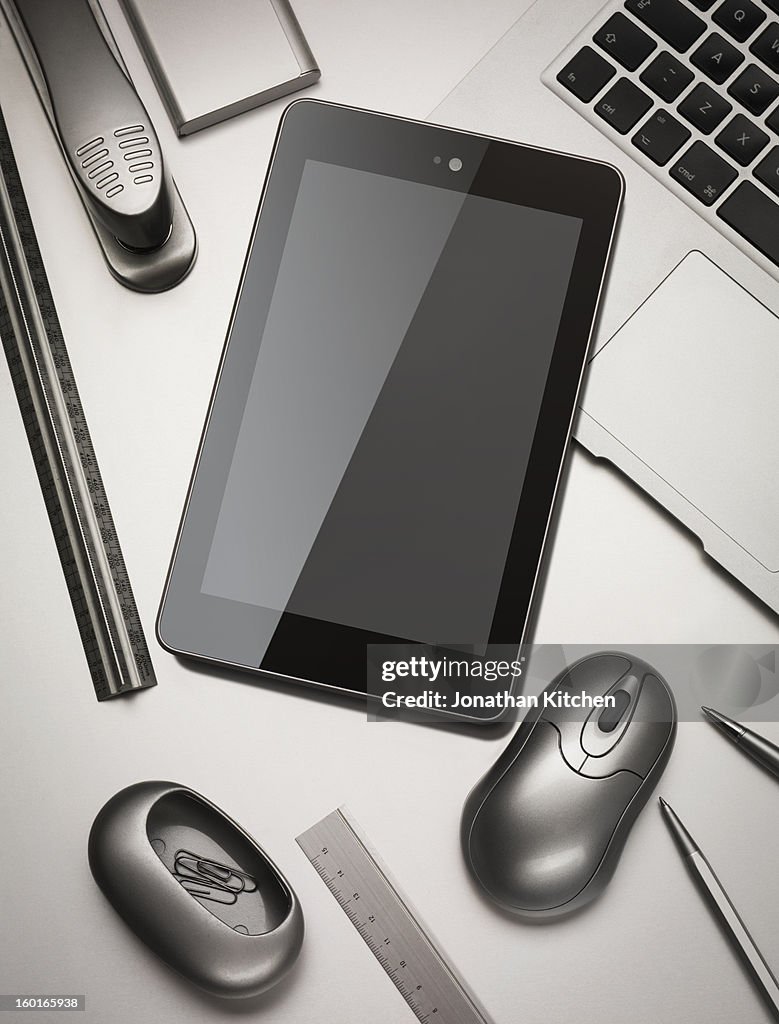 Tablet computer angled on silver desk