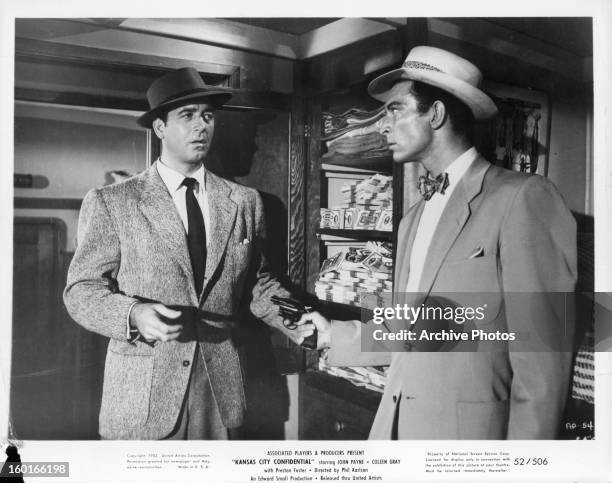 John Payne is threatened by Lee Van Cleef in a scene from the film 'Kansas City Confidential', 1952.