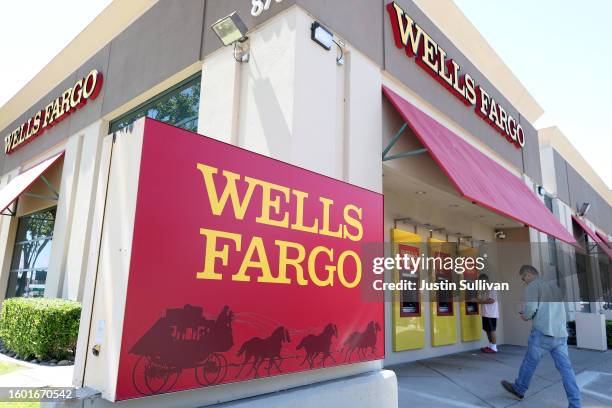 Wells Fargo customers use the ATM at a bank branch on August 08, 2023 in San Bruno, California. The Securities and Exchange Commission has fined...