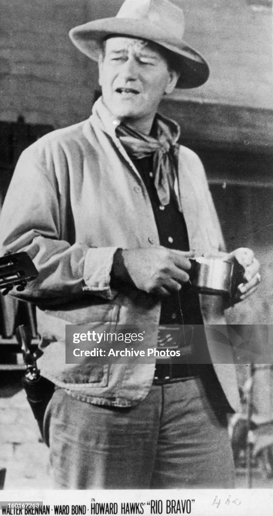 John Wayne holding cup in a scene from the film 'Rio Bravo', 1959. News