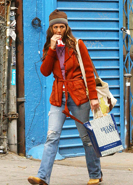 Actress Jennifer Aniston eats a candy bar while on the comedy set of a new unnamed movie November 10, 2002 in New York City. Actor Ben Stiller...