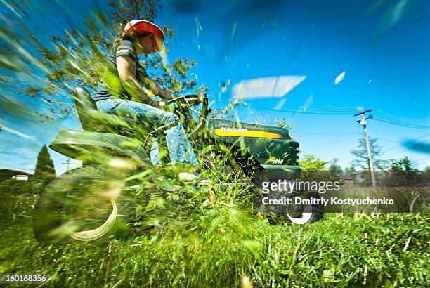 grassplosion - riding lawnmower stock pictures, royalty-free photos & images