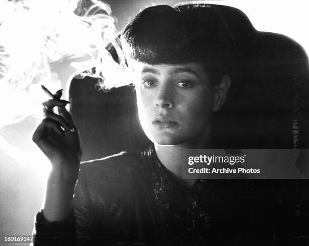 Sean Young smokes in a scene from the film 'Blade Runner', 1982.