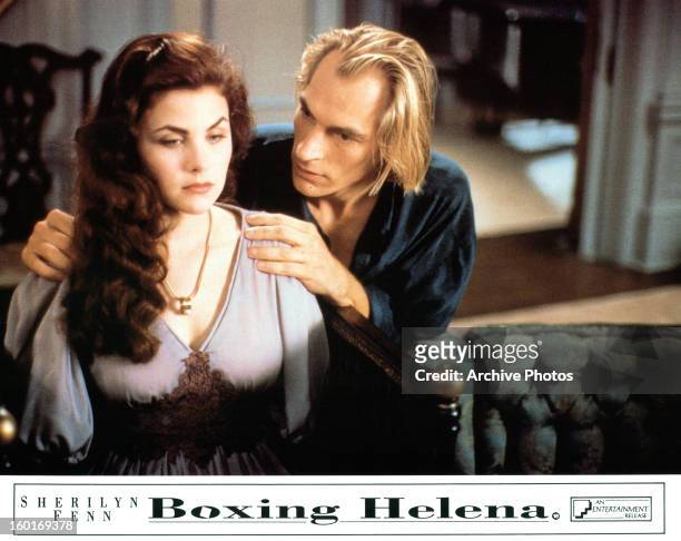 Sherilyn Fenn sits as Julian Sands holds her shoulders in a scene from the film 'Boxing Helena', 1993.