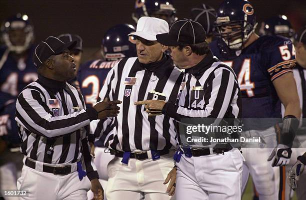 Officials, including referee Bob McElwee and umpire Jeff Rice attempt to make a decision late in the game between the Chicago Bears and the New...