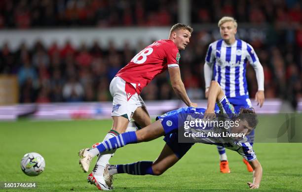 Sam Dalby of Wrexham and Kelland Watts of Wigan Athletic compete for the ball during the Carabao Cup First Round match between Wrexham and Wigan...