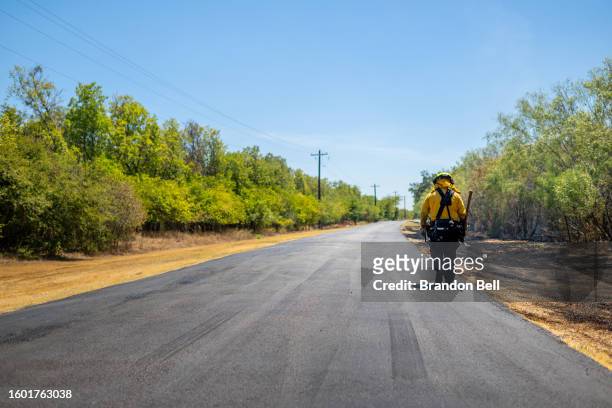 Firefighter prepares to put out a wildfire during an excessive heat warning on August 08, 2023 in Hays County, Texas. The city of Austin and its...