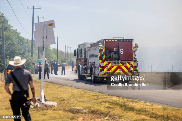 Members of the Hays County Emergency Service Districts and the Kyle and Buda Fire Departments prepare to combat a wildfire during an excessive heat...