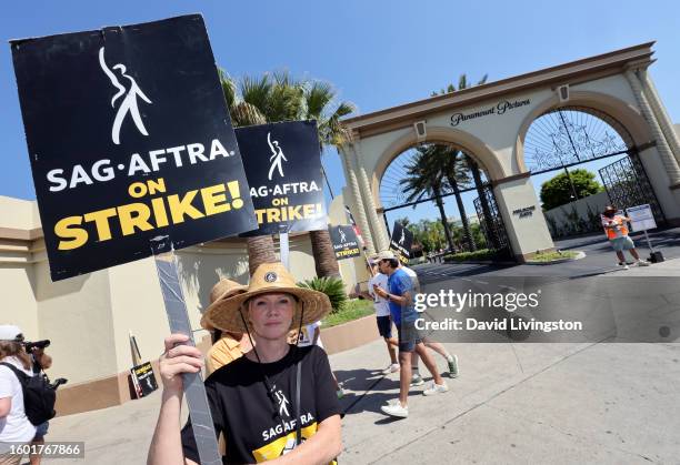 Tara Buck walks the picket line at Paramount Studios on August 08, 2023 in Los Angeles, California. Members of SAG-AFTRA and WGA have both walked out...