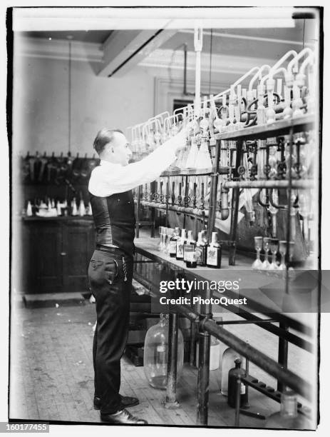 Internal Revenue Bureau chemist George F. Beyer tests bootleggers' booze in his laboratory, 1920.