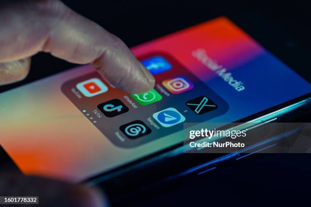 Close - up finger pointing to Whatsapp mobile app displayed on a smartphone screen alongside that of Facebook, X,Telegram,TikTok,Threads. On 15...