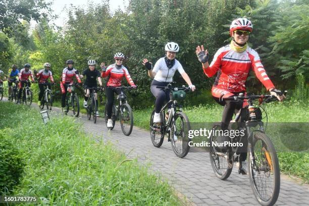 Citizens ride during a publicity event on ''National Ecology Day'' in Handan, Hebei province, Aug 15, 2023.