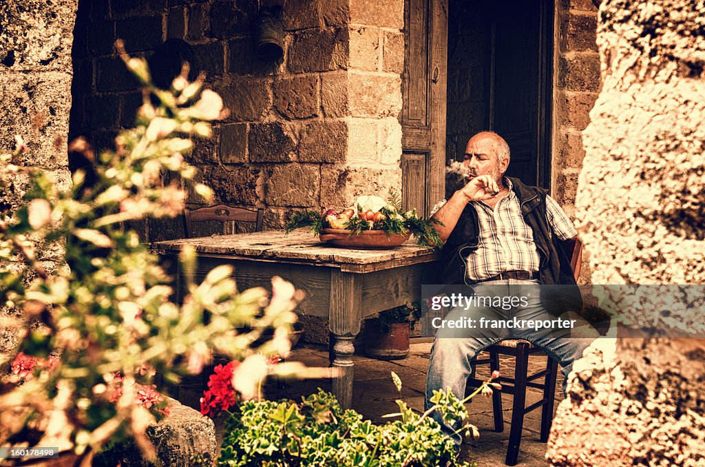 Senior farmer man smoking cigar