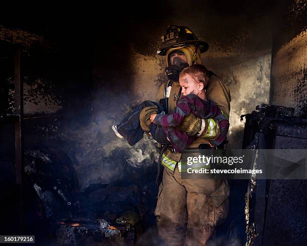 firefighter carrying boy - gas pump help stock pictures, royalty-free photos & images