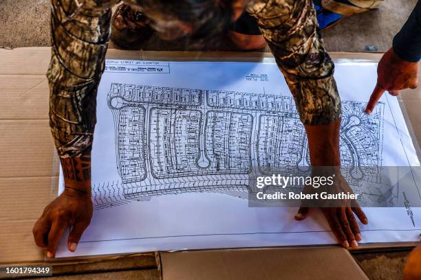 Lahaina, Maui, Monday, August 14, 2023 - Volunteers prepare a map that will be used to document homes that need roof repair before a predicted...