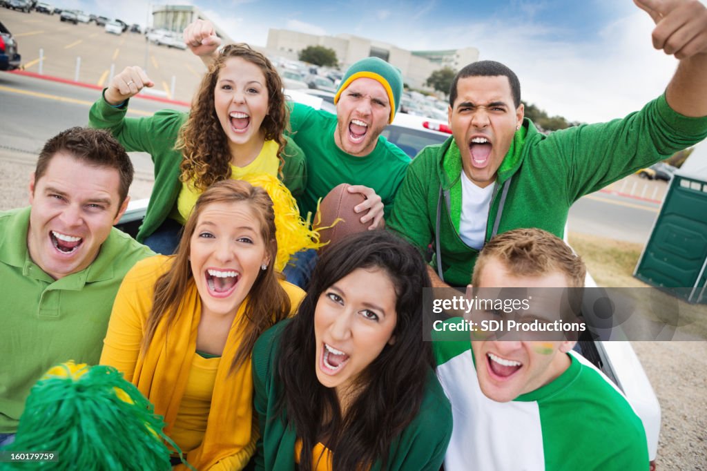 Group of crazy fans at college football stadium tailgate party