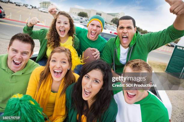 group of crazy fans at college football stadium tailgate party - football tailgate stock pictures, royalty-free photos & images