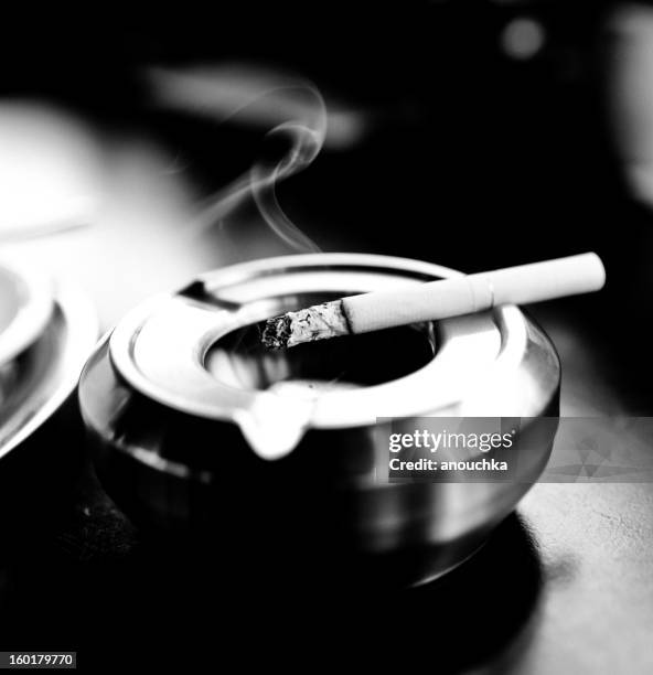 cigarette in ashtray - ashtray stock pictures, royalty-free photos & images