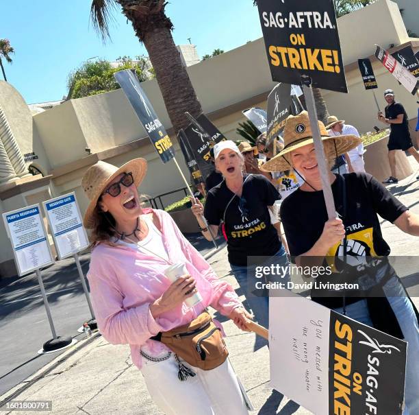 Michelle Forbes, Nana Visitor and Tara Buck walk the picket line at Paramount Studios on August 08, 2023 in Los Angeles, California. Members of...