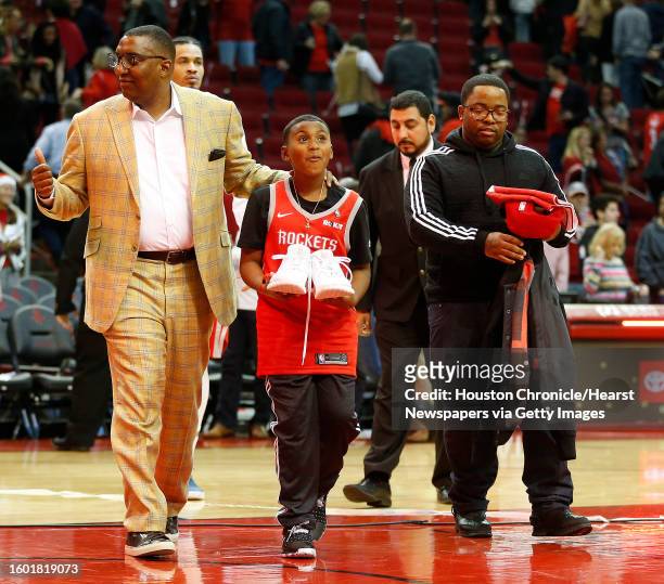 Chance "CJ" Smith, the Make-A-Wish kid, who was given a one-day contract with the Houston Rockets, reacts after James Harden gave him his shoes after...
