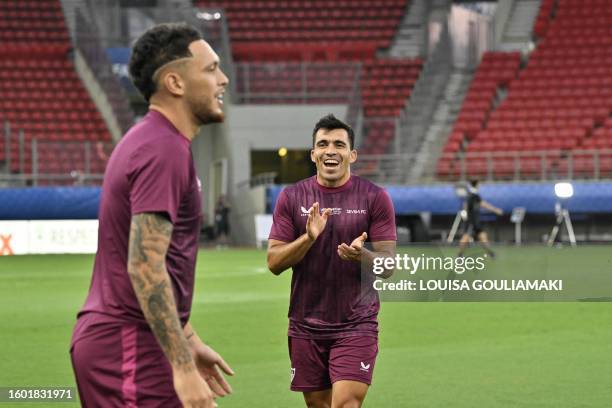 Sevilla's Agrentinian defender Marcos Acuna cheers as he takes part in a training session on the eve of the UEFA Super Cup football match between...