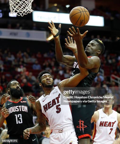 Houston Rockets center Clint Capela tries to get the rebound against Miami Heat forward Derrick Jones Jr. During the first half of an NBA game at...