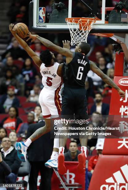Houston Rockets forward Gary Clark tries to stop a basket attempt by Miami Heat forward Derrick Jones Jr. During the first half of an NBA game at...