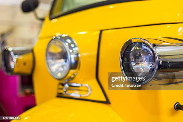 front lights of a yellow tuktuk - auto rickshaw stock pictures, royalty-free photos & images