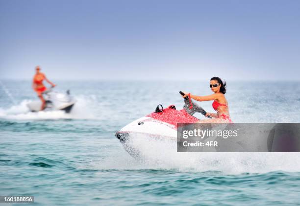 hot girls on jet skis / waverunner in tropical water - hot polynesian girls stock pictures, royalty-free photos & images